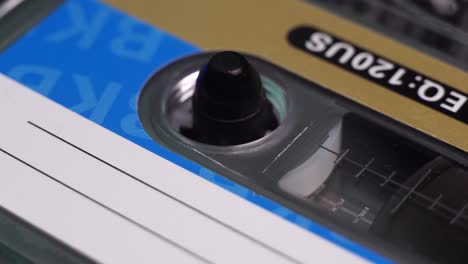 close up of audio cassette tape reel spinning during playback or recording