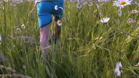 child running through a field of daisies