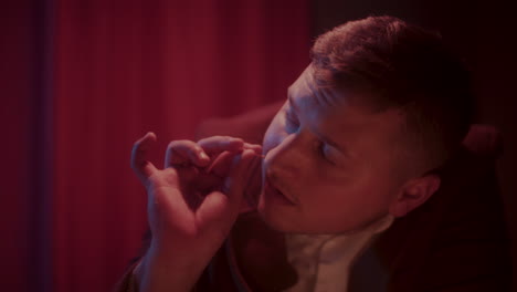 man taking a pill in a dark room