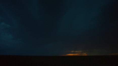 Bolts of lightning under dark storm clouds as daylight fades away