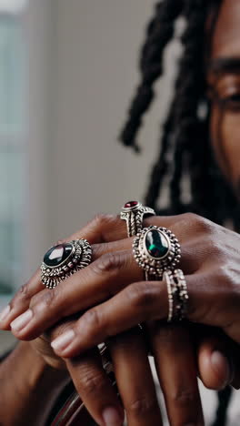 close-up of hands adorned with ornate gemstone rings