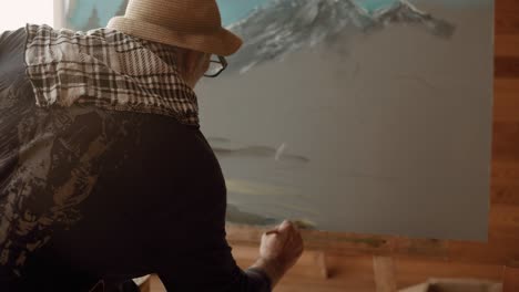 an artist painting a mountain landscape