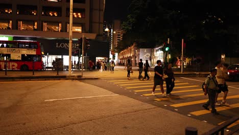 people crossing street with traffic and lights