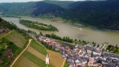 bacharach german town in middle rhine valley with its timbered medieval houses and vineyards overlooking waterway transportation barge ships