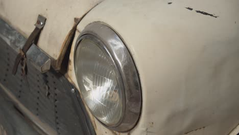 round front lamp of antique rustic car in white color, close up motion view