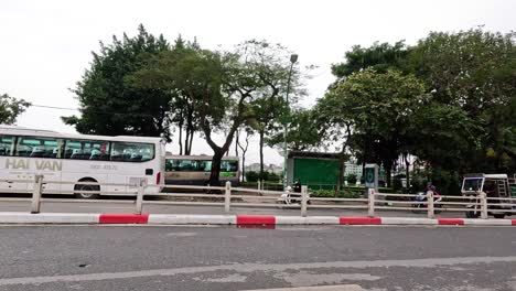 vehicles and buses navigate a busy hanoi road