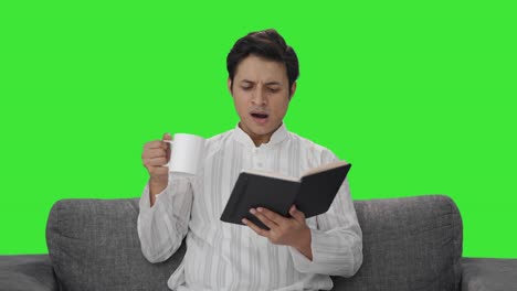 Tired-Indian-man-reading-a-book-Green-screen