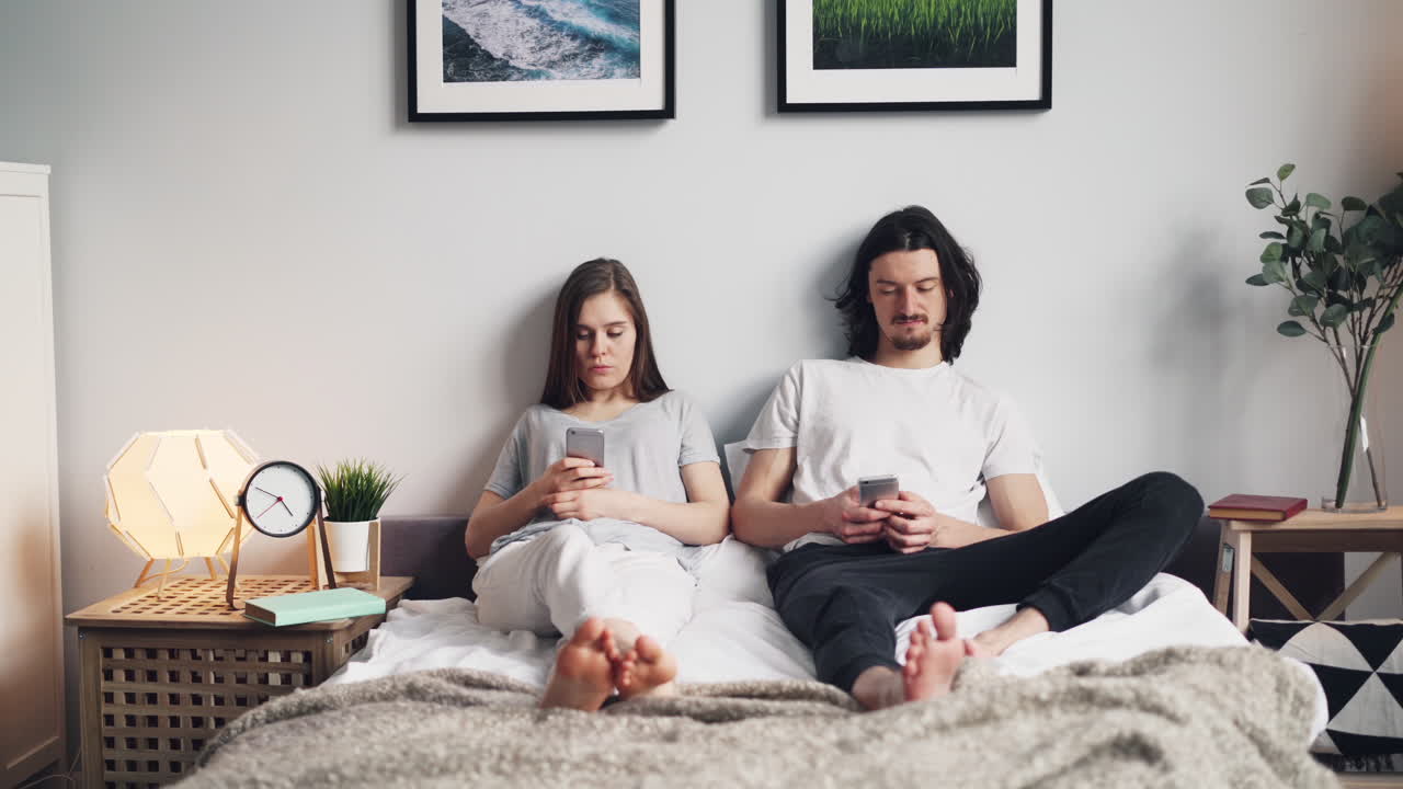 Couple on Bed with Smartphones