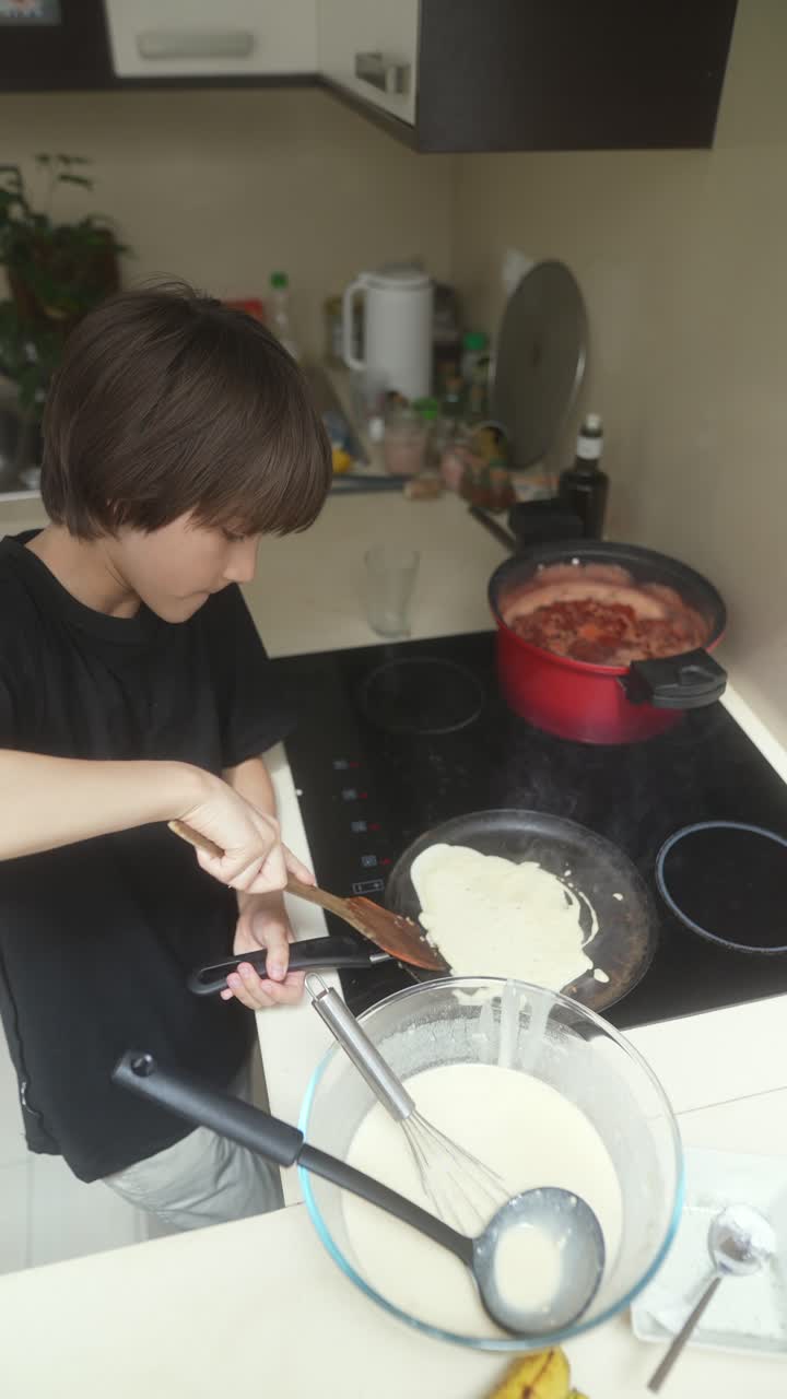 A Young Boy Cooking Pancakes