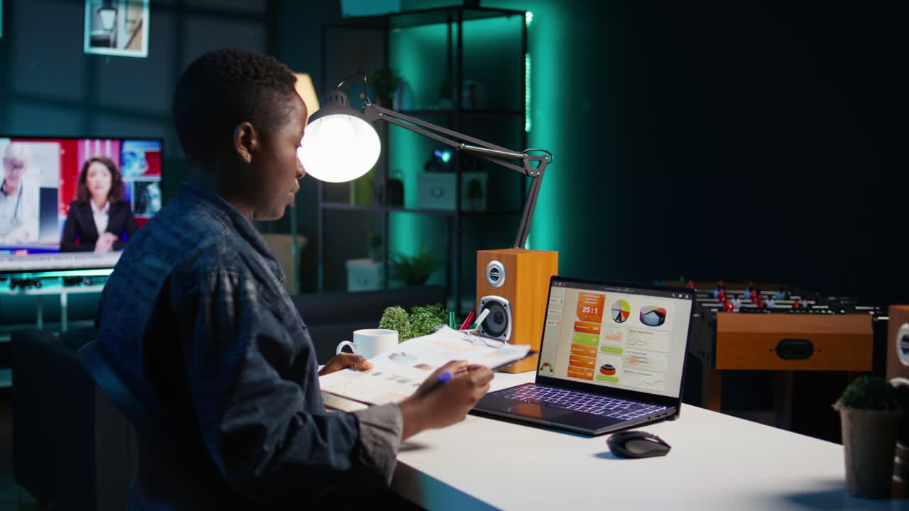 Woman analyzing data at home at night