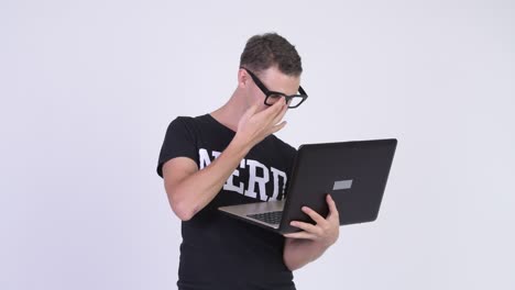 nerd man with eyeglasses using laptop