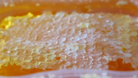 close up of fresh honey with comp in a jar