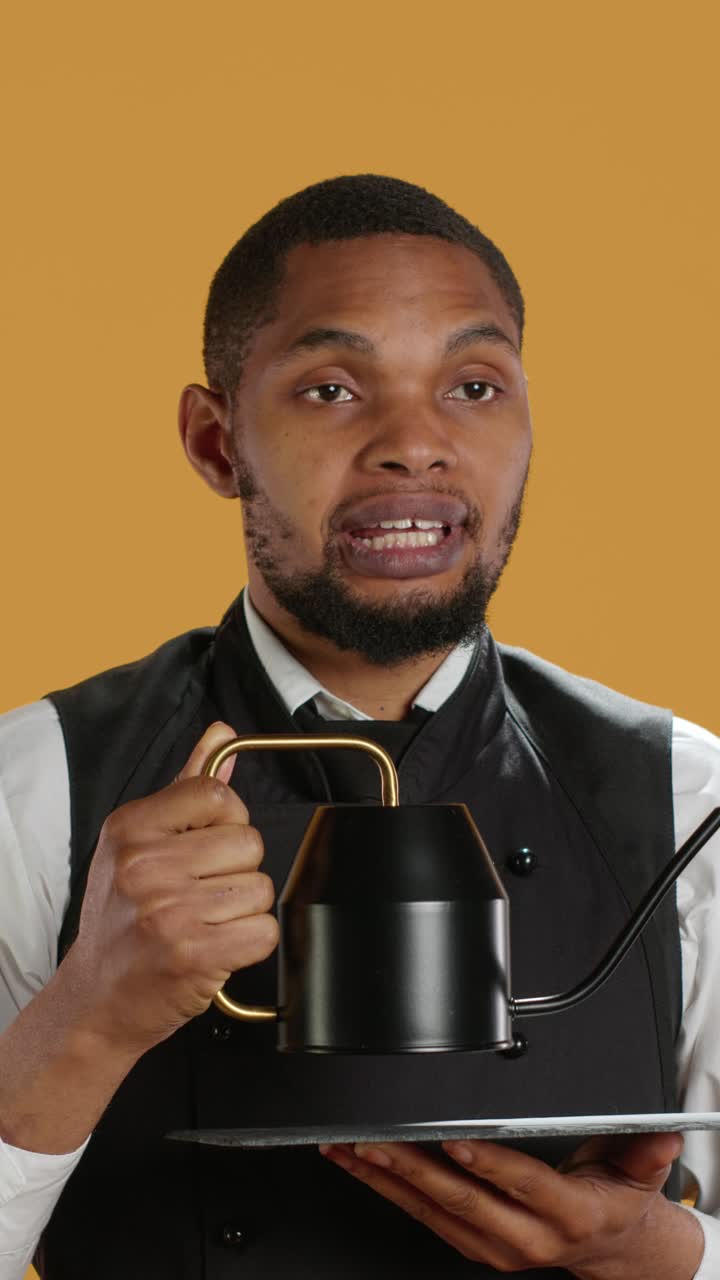 African American Barista Holding Coffee Kettle and Talking
