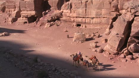 people ride donkeys and camels near the ancient amphitheater in the ancient nabatean ruins of petra jordan