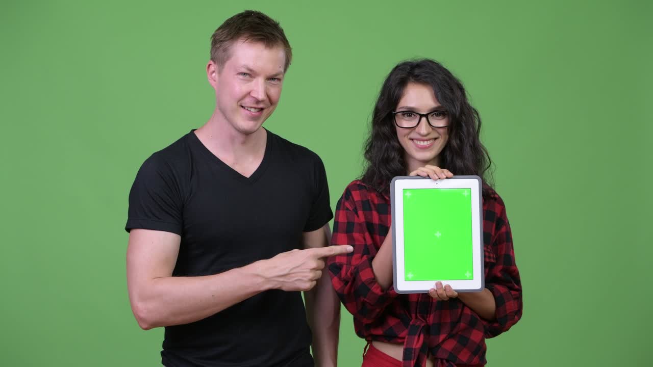 Young couple showing digital tablet together