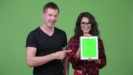 young couple showing digital tablet together