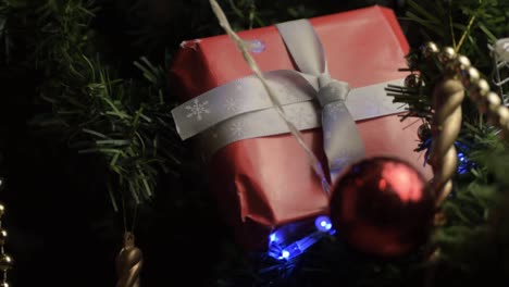 Christmas-tree-decorated-with-lights-baubles-and-gift