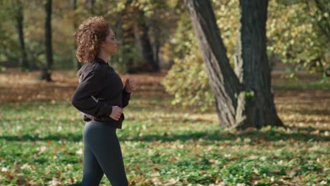 caucasian of ginger woman jogging at the park in autumn