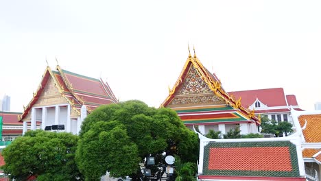 a tranquil scene of wat prayurawongsawat temple with lush greenery and traditional architecture under soft daylight