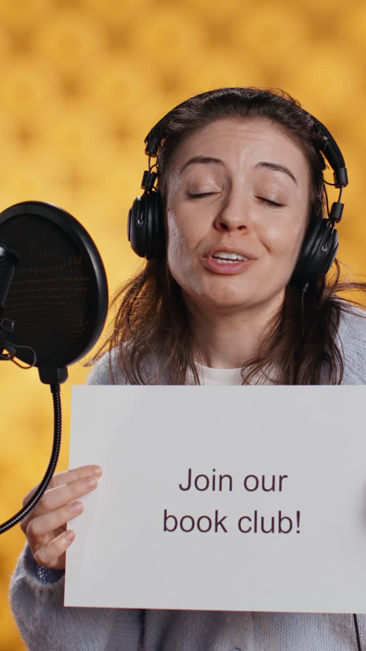 Woman Podcaster with Headphones Holding 'Join Our Book Club' Sign