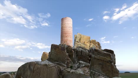 ancient stone pillar on a rocky outcrop