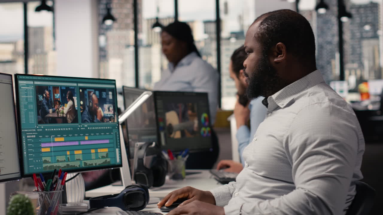 Black man working on film footage editing and cutting clips for motion graphics