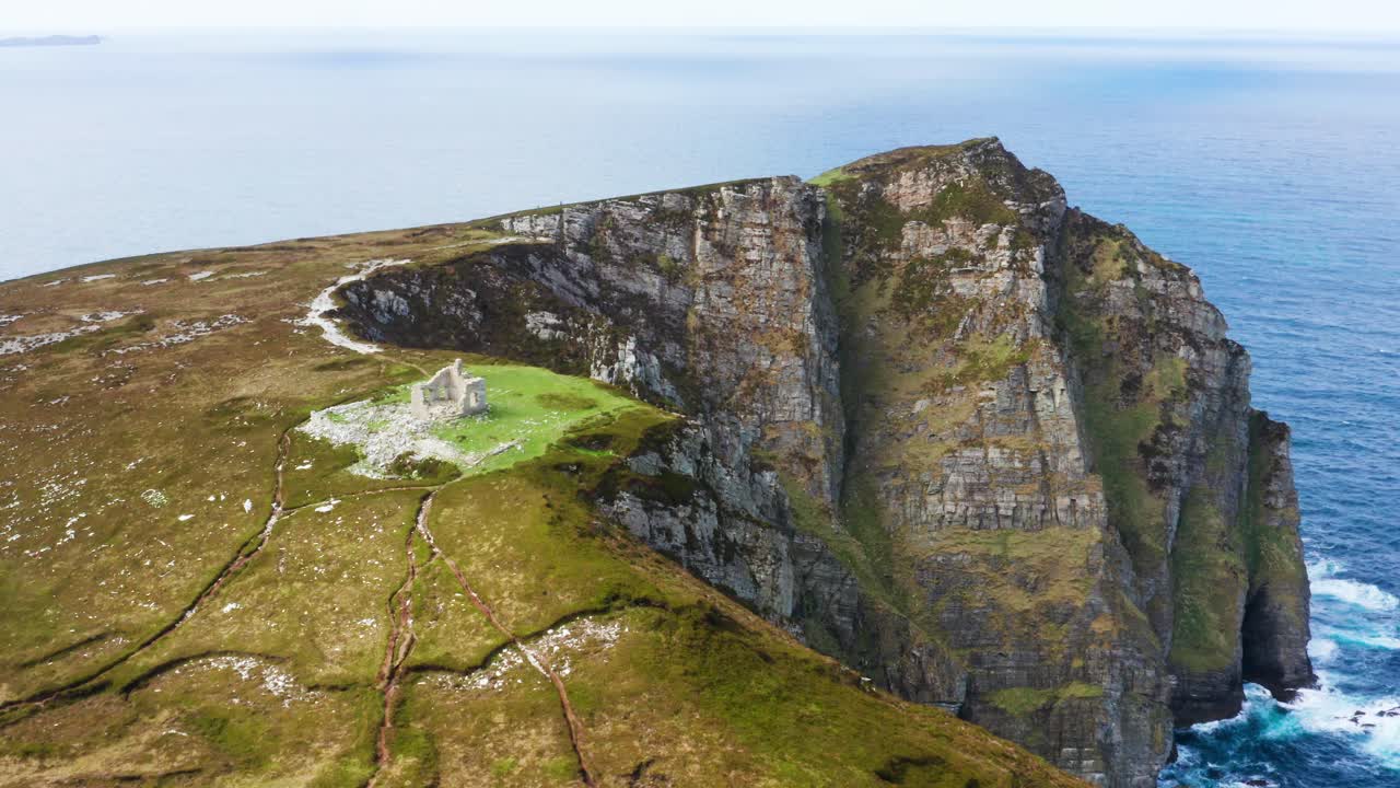 Aerial view of Horn Head with Napoleonic ruins overlooking steep cliffs and the Atlantic on a clear summer day
