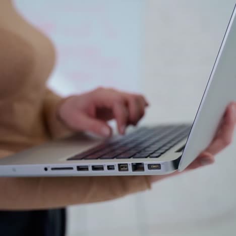 . typing on laptop, close up. close up of female hands typing text on laptop keyboard