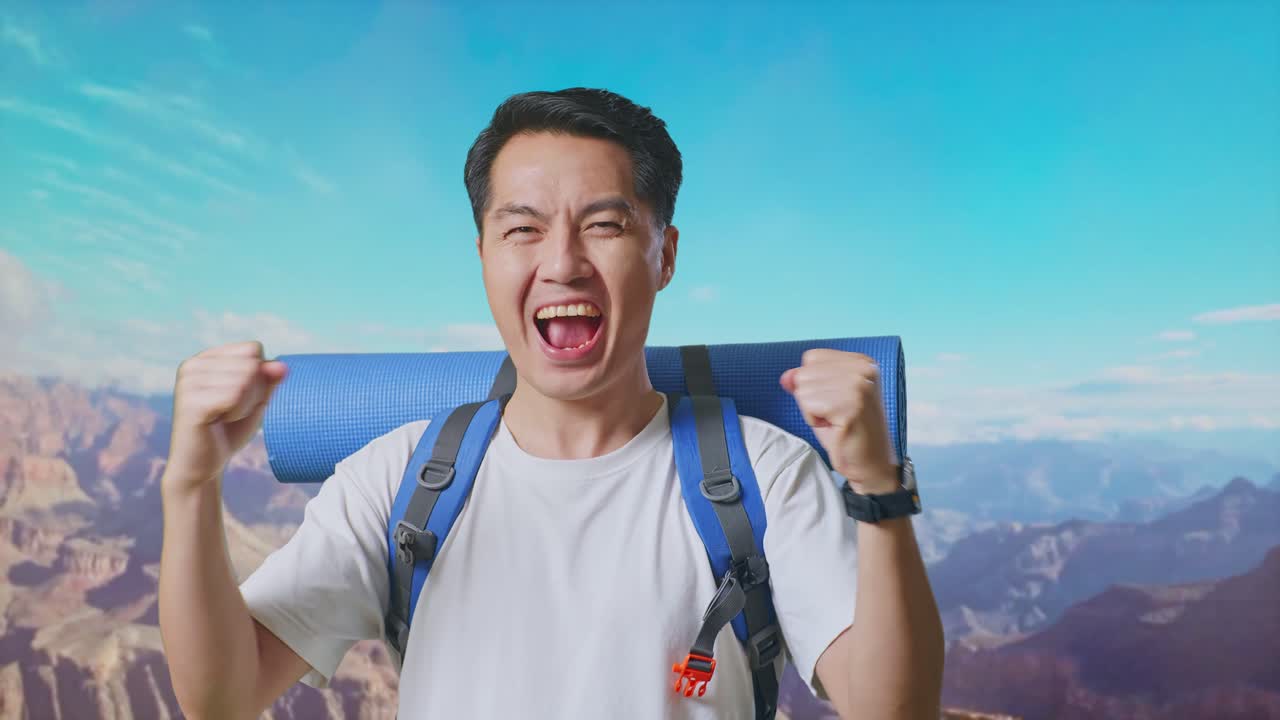 Close Up Of Asian Male Hiker With Mountaineering Backpack Screaming Goal Celebrating The Success While Traveling At The Top Of Mountain