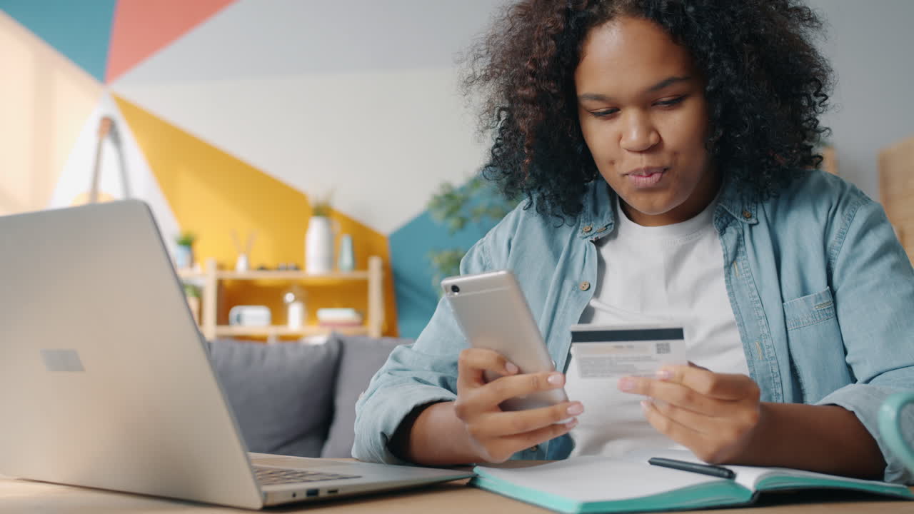 Woman using mobile phone and credit card for online shopping