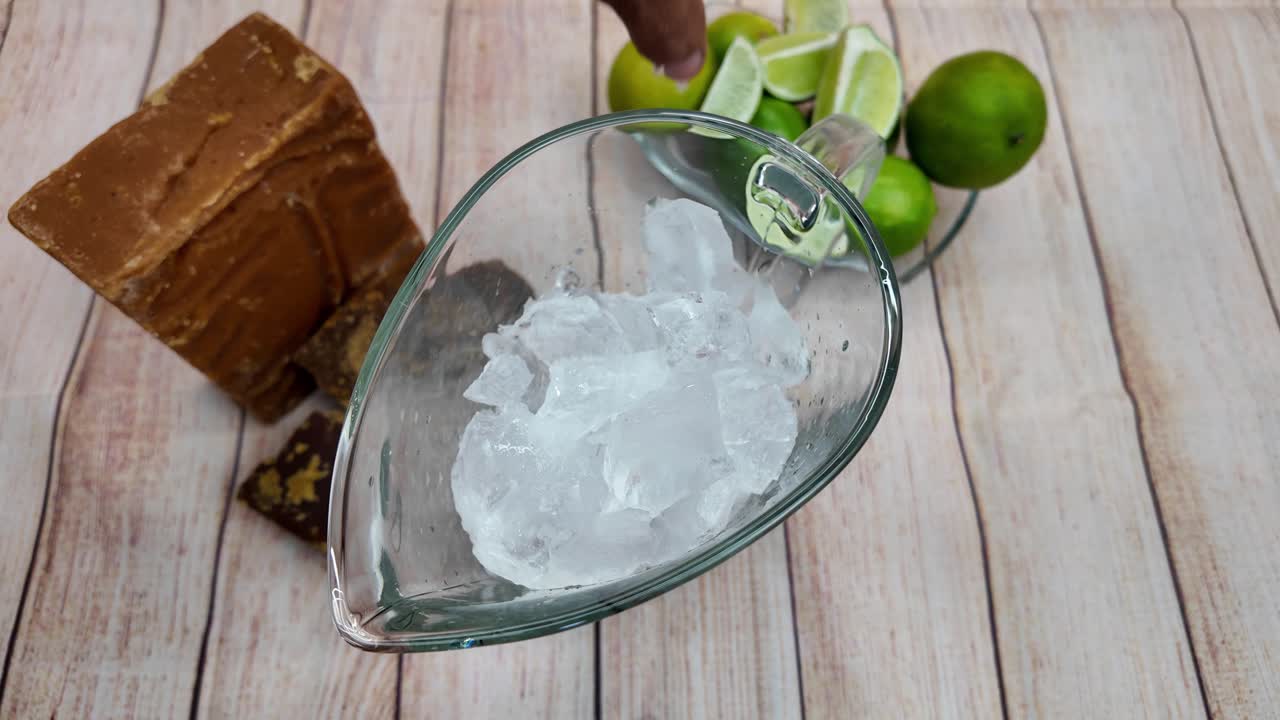 Overhead insert shot raw cane sugar Panela Piloncillo and fresh limes used to create the classic, sweet, and refreshing South American drink