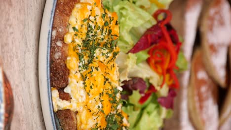 scrambled eggs on bread with salad