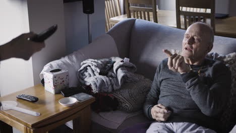an elderly man sitting on a couch