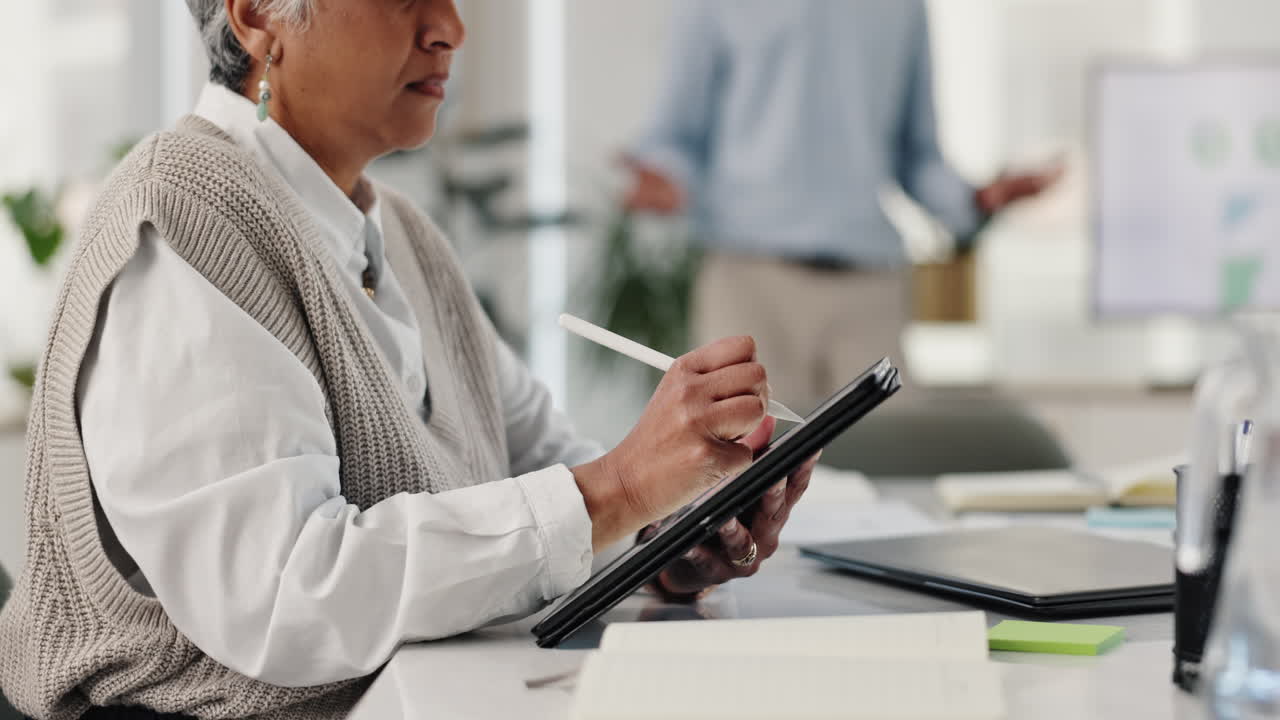 Senior woman working on a tablet in an office