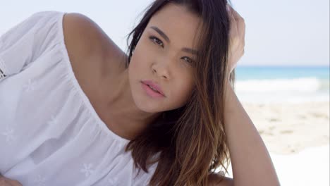 Sultry-brunette-in-white-blouse-stares-at-camera