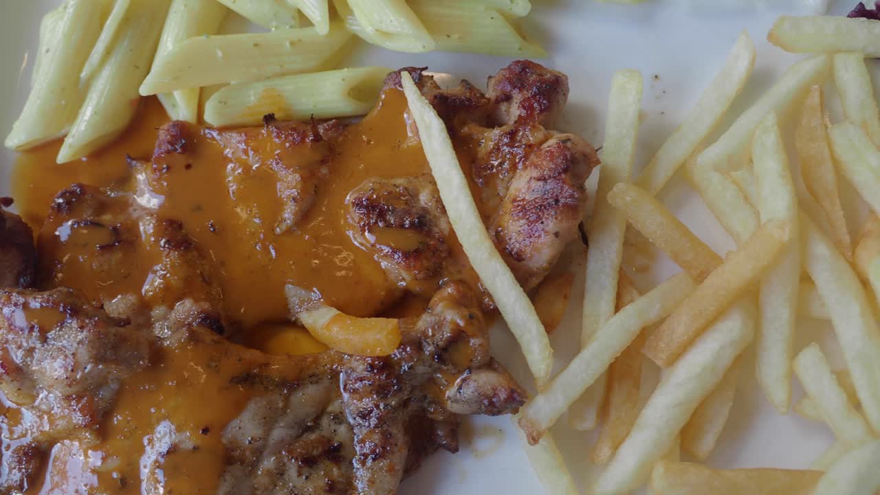 Chicken with pasta and french fries