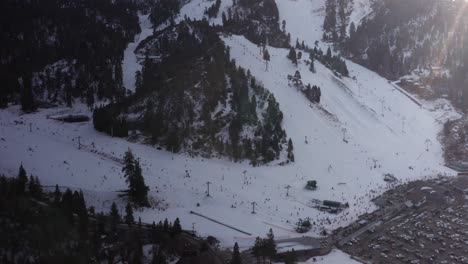 Aerial-close-up-and-tilting-up-shot-of-the-ski-and-snowboarding-slopes-at-Bear-Mountain-ski-resort-in-Big-Bear-Lake,-CA