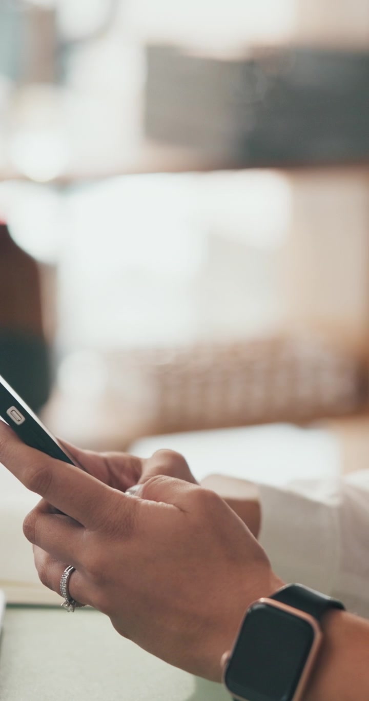 Close-up of Woman Using Smartphone in Bright Office