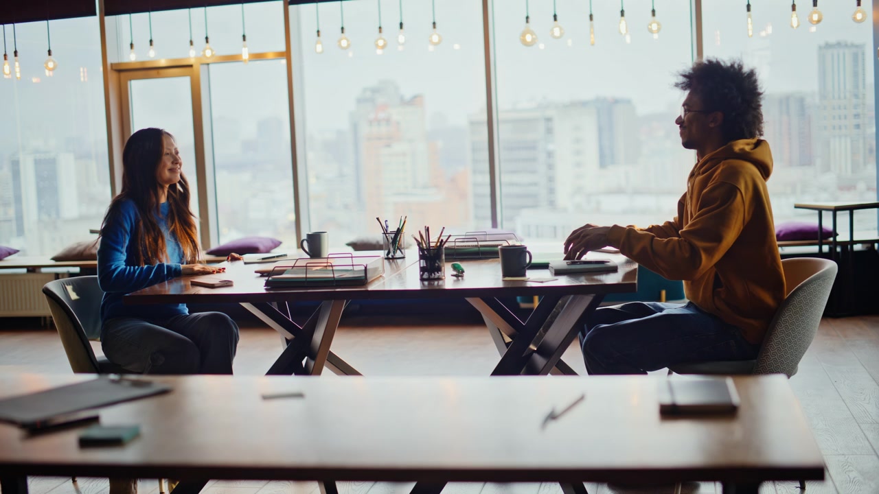 Multiethnic team sitting coworking table coffee. Morning teamwork office space.