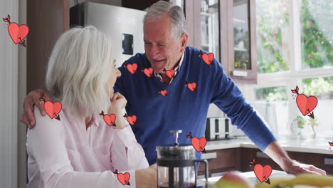 Animación-De-Corazones-Sobre-Una-Feliz-Pareja-Caucásica-Mayor-Tomando-Café