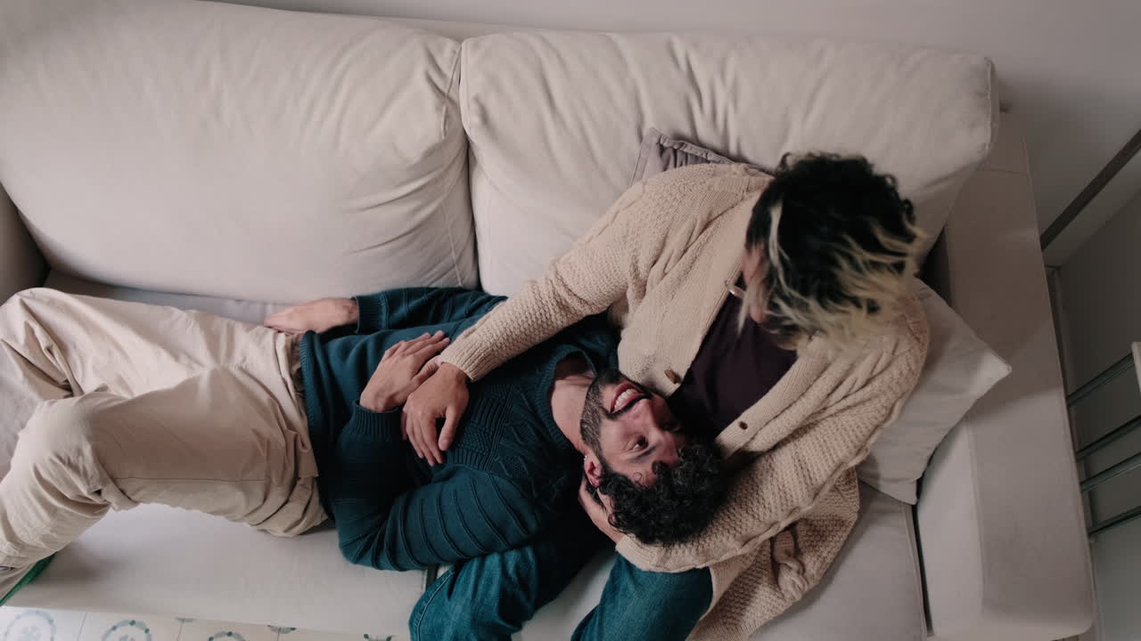 Gay Couple Relaxing Together At Home