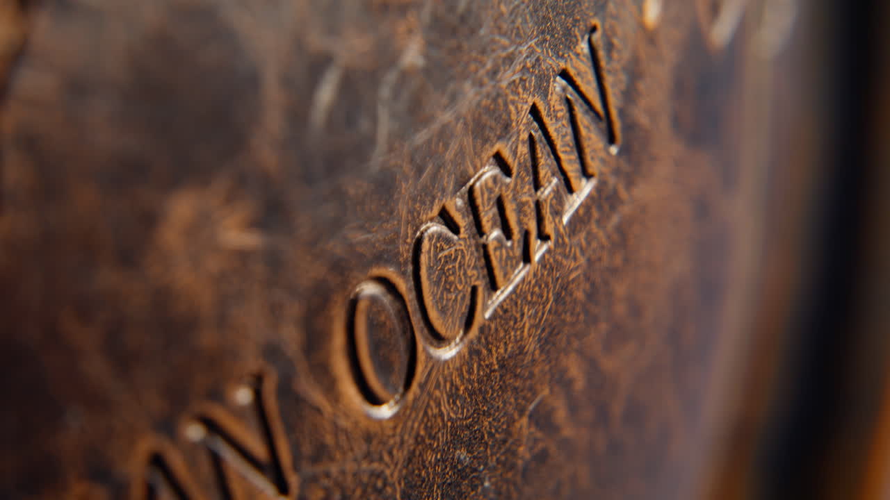 Macro view globe texture with Indian ocean name. Geographical elements engraved