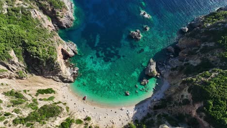 giali beach in corfu with clear blue waters and sandy shore, greece, aerial view