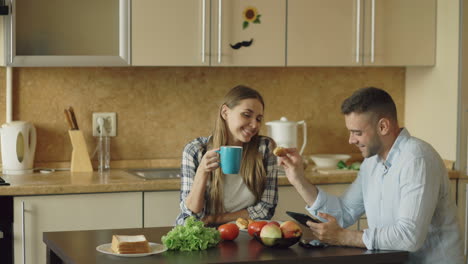 couple having breakfast in kitchen