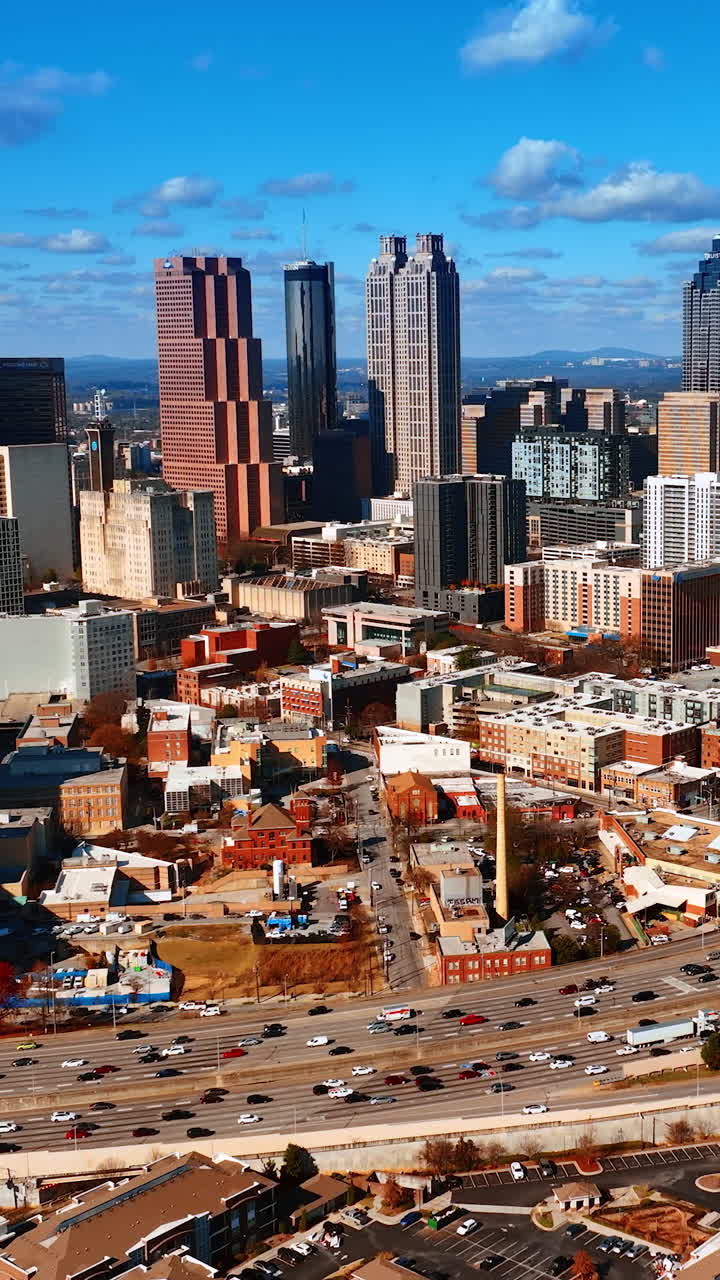 Scenic daytime view of huge metropolis downtown with heavy traffic. Panorama of Atlanta, Georgia, USA from top. Vertical video