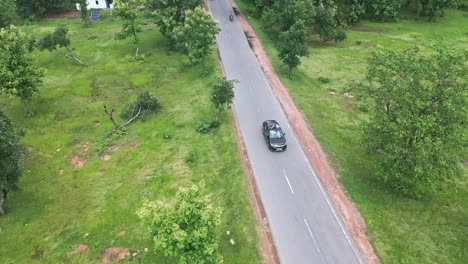 SUV-Car-Driving-On-The-Road-With-Indian-Woman-Standing-Through-Open-Sunroof