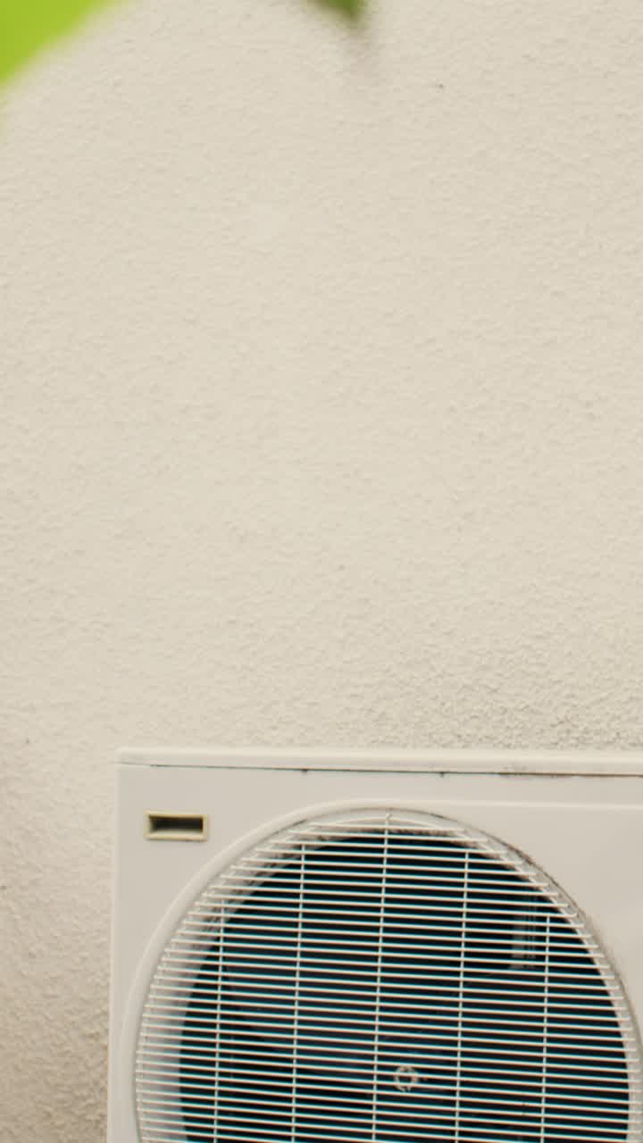 Vertical video Repairman starts hvac system maintenance