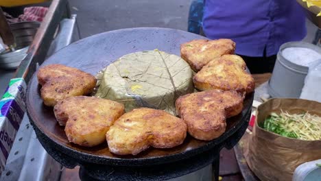 close up shot over tasty heart shaped potato pakora along a roadside stall in kolkata, india at daytime