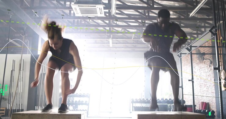 Two athletes squatting and exploding into box jumps for gym training, motion lines tracing paths