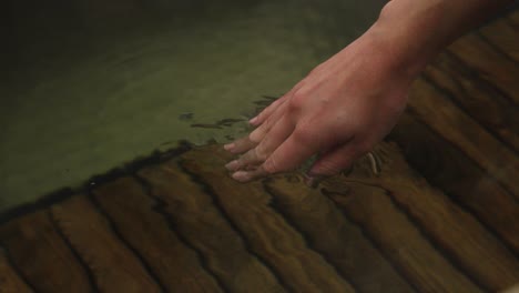 close up shot of hand in outdoor bath